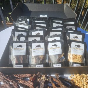 Black hamper gift box with 21 packs of biltong, chilli bites, and dry wors, plus 7 packs of roasted peanuts