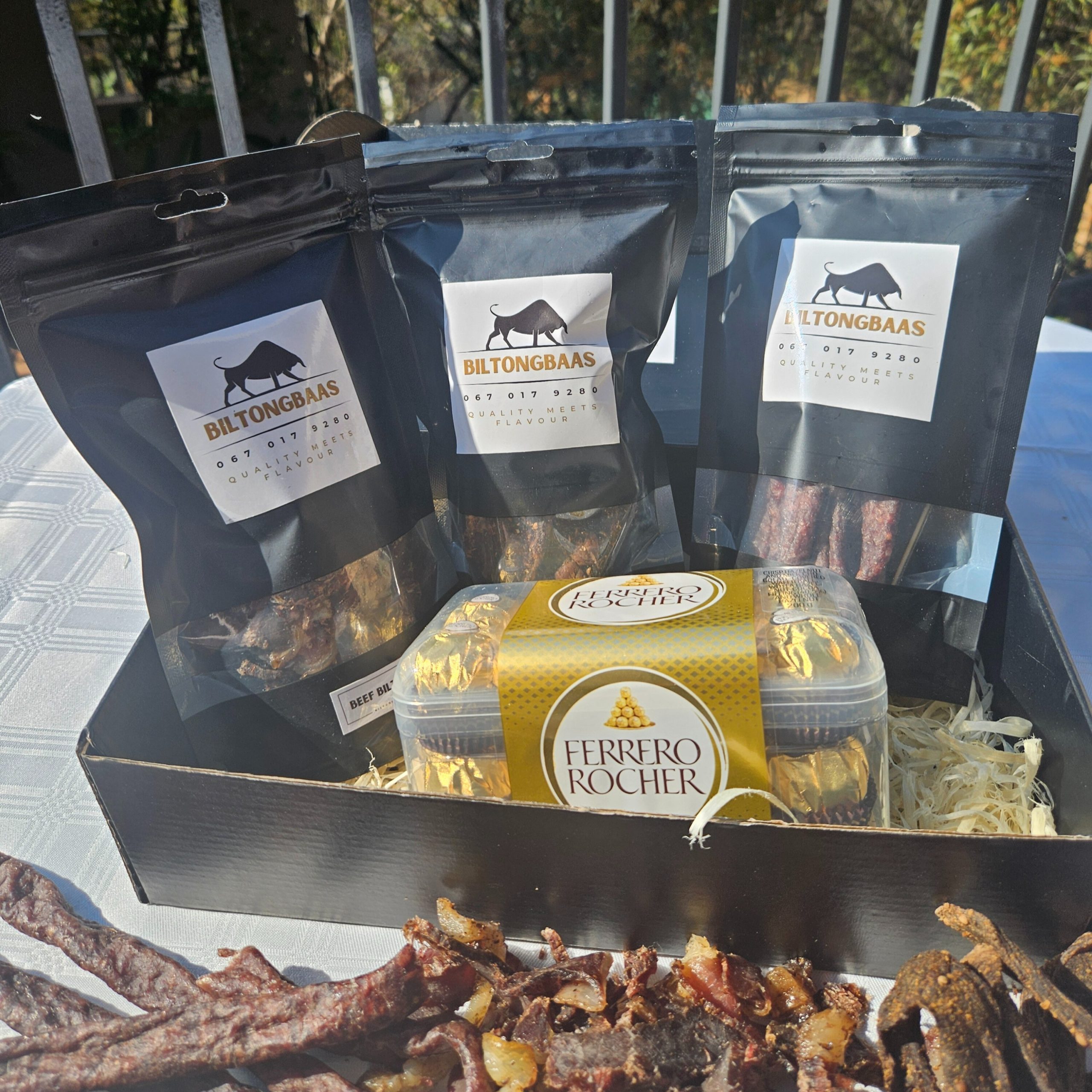 Gift box with 3x 150g selections of biltong, chilli bites, or dry wors paired with Ferrero Rocher chocolates