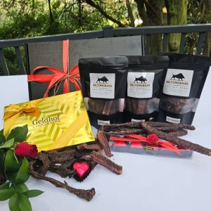 Premium Biltong & Chocolates Large gift box with 100g biltong, 100g droëwors, 100g chilli bites, a Geldhof gold box of 12 assorted handmade chocolate truffles, and 5 hazelnut chocolate truffle hearts.